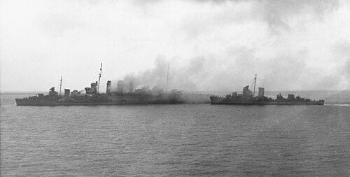 Destroyers removing crew from HMAS Canberra after the Battle of Savo Island, 9 August 1942. USS Blue is alongside Canberra's port bow, as USS Patterson approaches from astern.