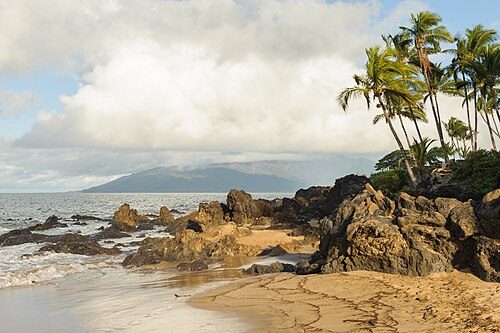 Volcanic rocks protrude on a Maui beach